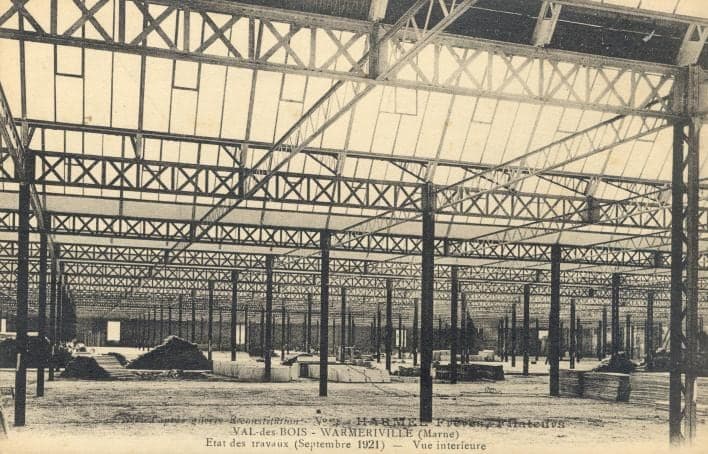 A forest of posts and steel trusses in the new hall, still without a roof, stretching into the distance.