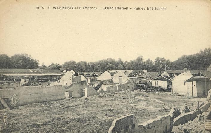 A vast flattened area inside the mill: low stretches of wall, debris and a few buildings still standing in the background.