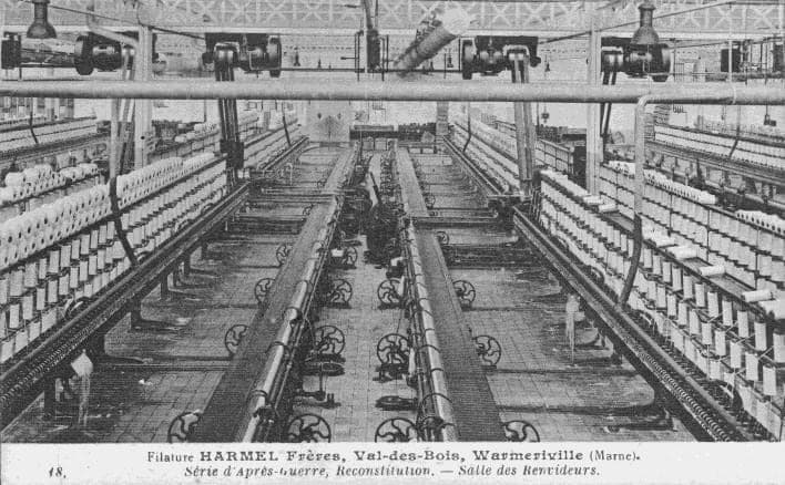 The self-acting mules of the rebuilt mill, in long parallel rows laden with white bobbins.