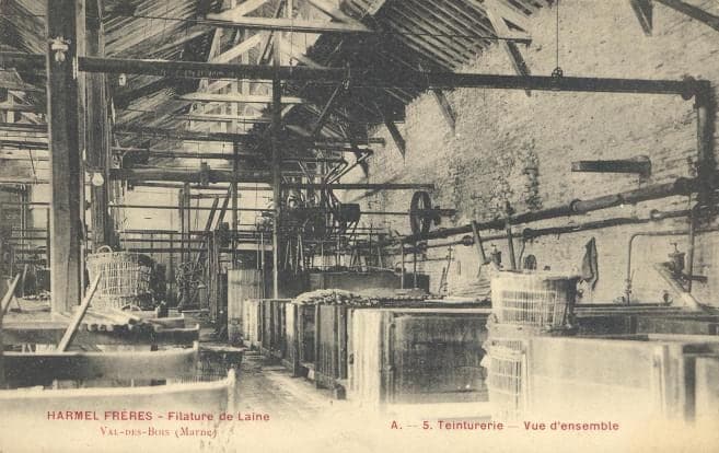 Inside the dye works under a timber roof: vats, baskets and belt-driven machines.