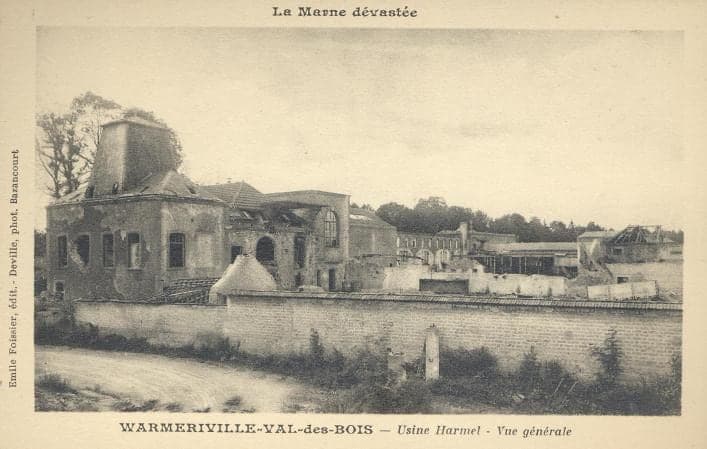 Behind a long boundary wall, the mill buildings gutted, their roofs collapsed and windows empty.