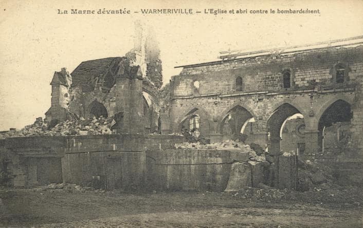 The ruined church of Saint-Martin in Warmeriville, reduced to its arcades and sections of wall, above a masonry shelter.